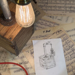 Photograph of lamp with wood base and industrial piping.