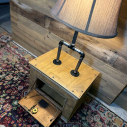 Lamp with wooden base and opened vintage mailbox door.